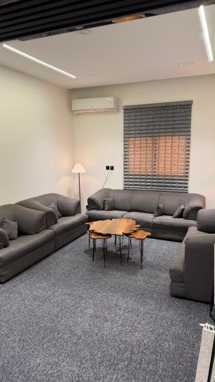 a living room with a couch and a table at Sweet Sbah in Hail