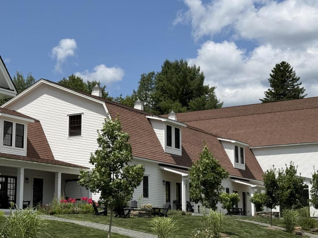 a white house with a brown roof at Luxury TownHome 106 in Wilmington