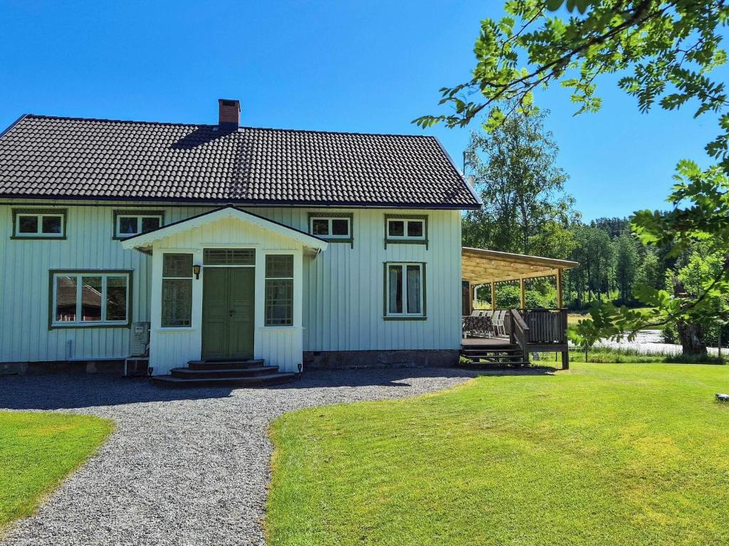 a house with a green door and a yard at 11 person holiday home in HÖGSÄTER-By Traum in Högsäter