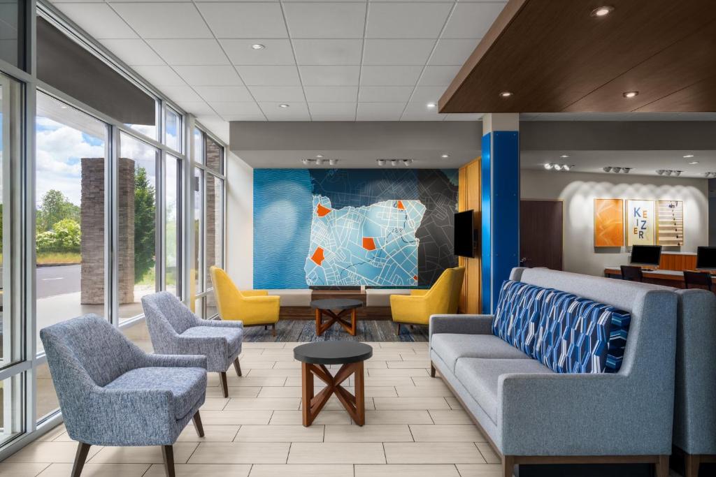 a lobby with couches and chairs in a building at Holiday Inn Express & Suites Salem North - Keizer by IHG in Keizer