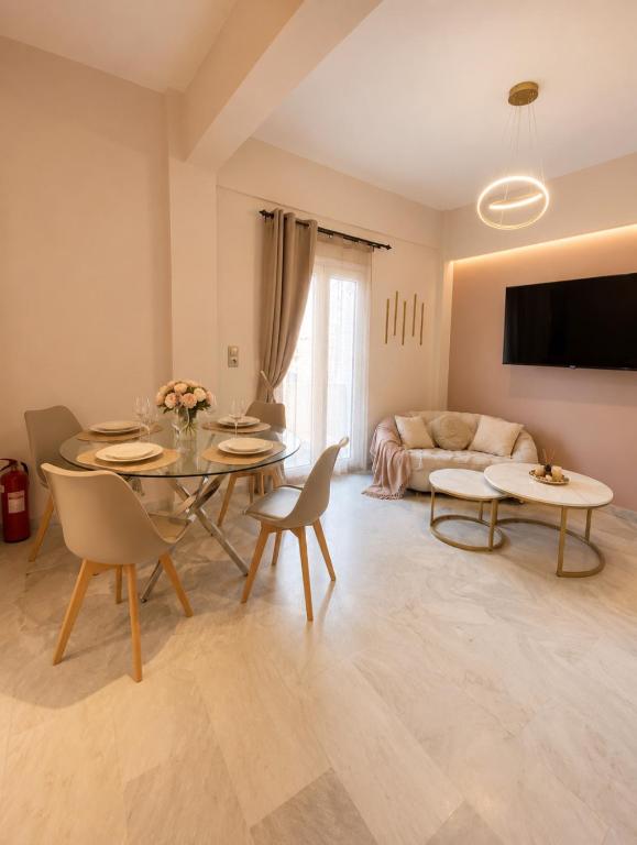 a living room with a table and chairs and a couch at Aris Studios in Karlovasi