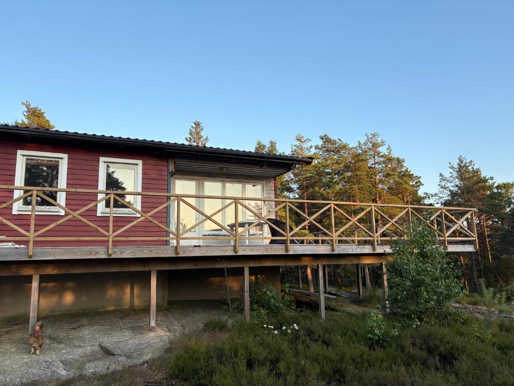 a house on a bridge with a dog looking out the window at Lilla stugan Orust in Svanesund