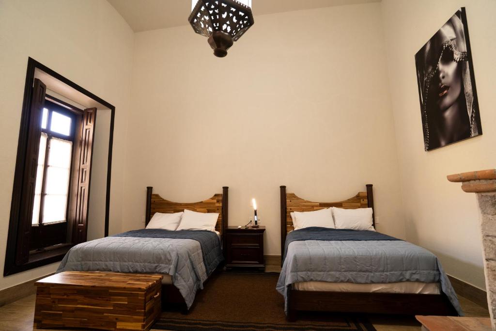 a bedroom with two beds and a window at Kali Doña Tere in Acámbaro