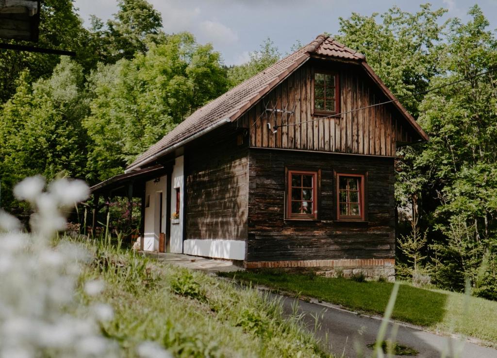 a small wooden house on the side of a road at Komora Lužná in Lužná