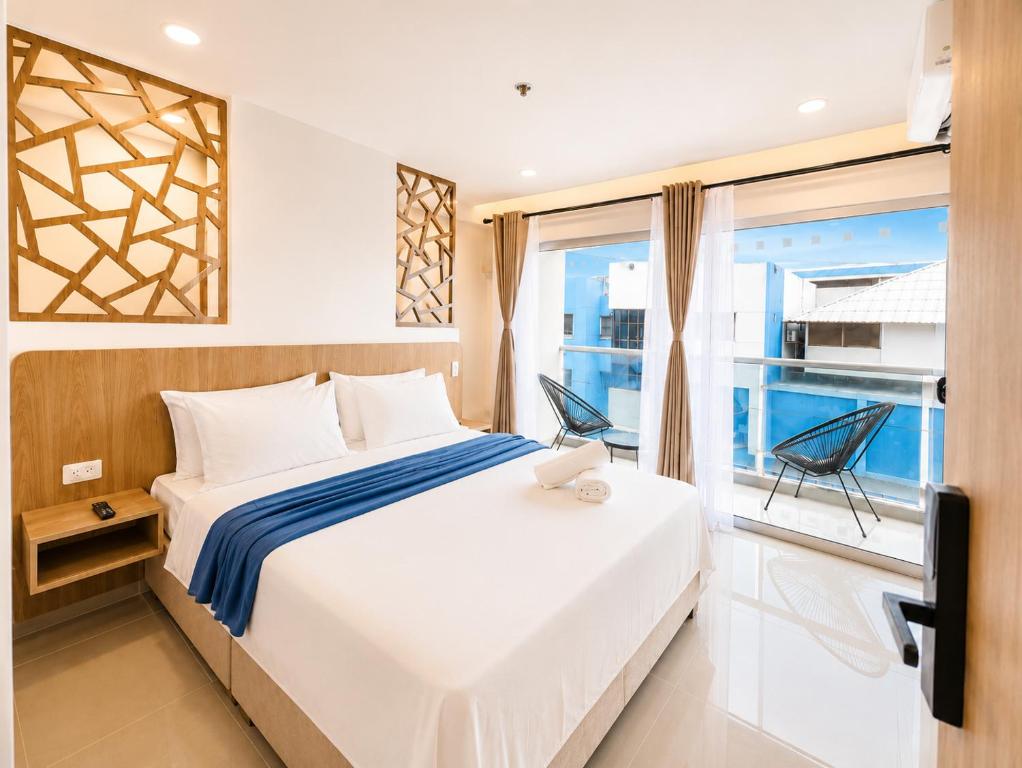 a bedroom with a large bed and a window at Hotel Azure Cartagena in Cartagena de Indias
