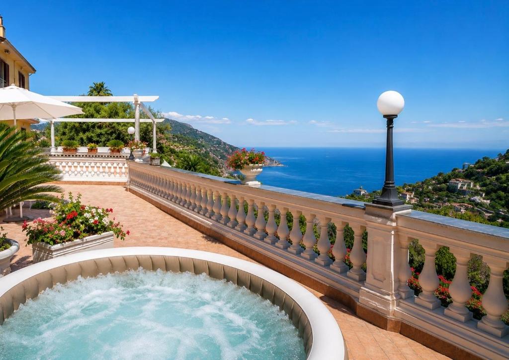 a hot tub on a balcony overlooking the ocean at Villa Costanza sorrento B&b in Sant'Agnello