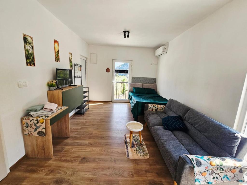 a living room with a couch and a table at Hikers place in Sutomore