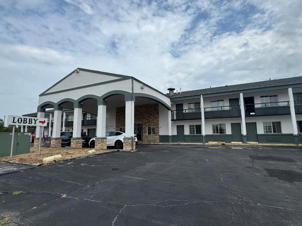 an empty parking lot in front of a hotel at Budget Host Inn in Salina