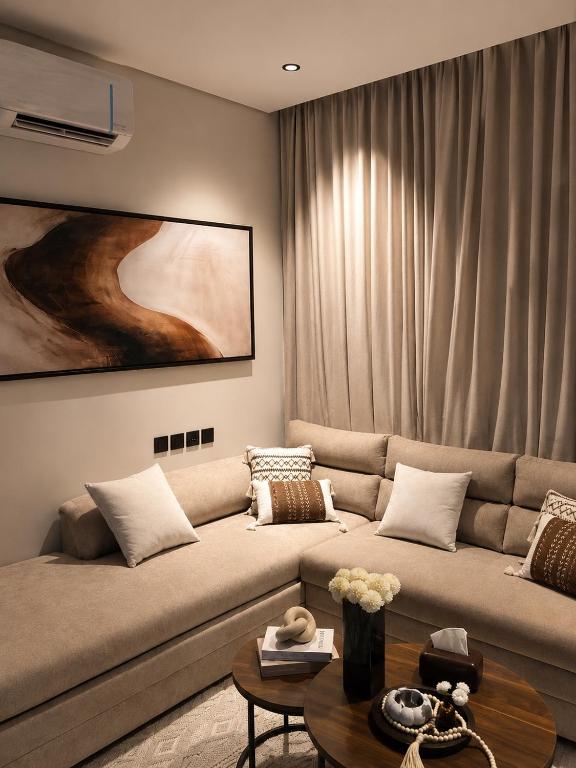 a living room with a couch and a table at Sukoon in Dammam