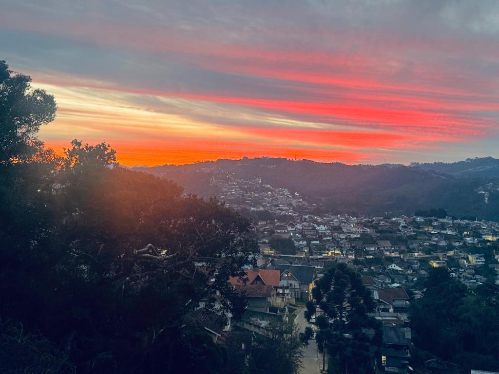 a view of a city at sunset at Refúgio dos ventos in Campos do Jordão