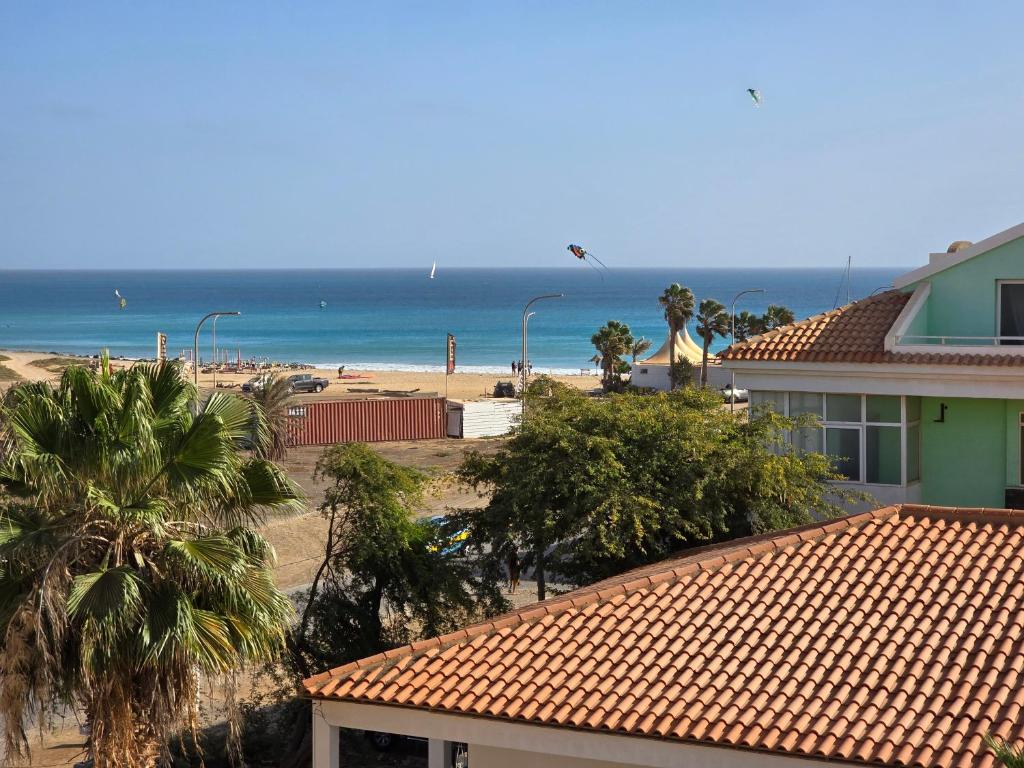 a view of a beach with a house and the ocean at Surf House Cabo Verde in Santa Maria