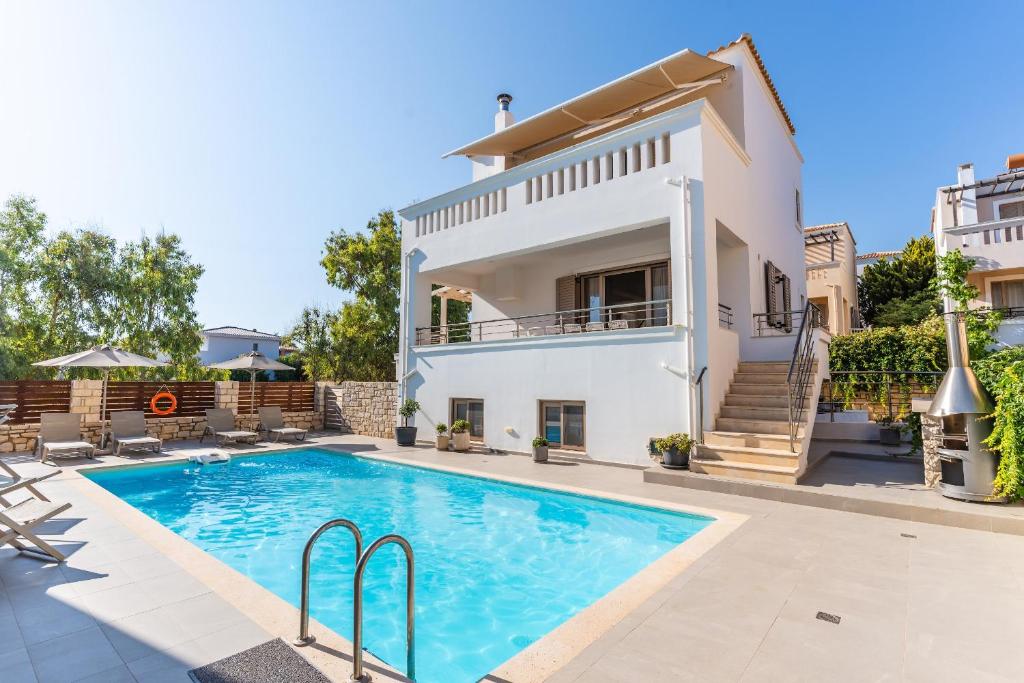 an image of a villa with a swimming pool at Villa Gagra - Villa by the Sea with a Private Pool in Panormos Rethymno