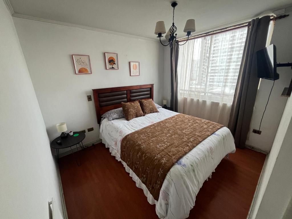 a bedroom with a bed and a window at Habitaciones con C in Concepción