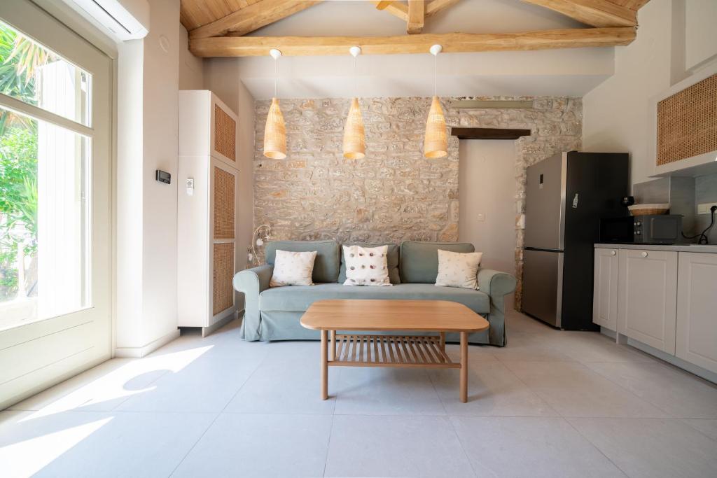 a living room with a couch and a table at Meraki Seaside Suite Pelion in Kalamos