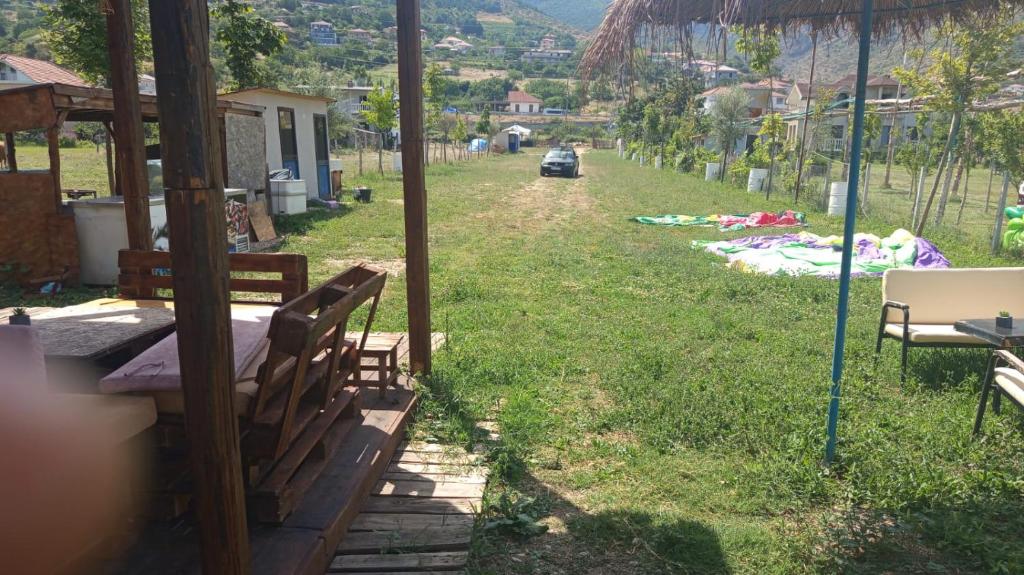 a view of a yard with benches in the grass at Camper Park Lake View in Mëmëlisht