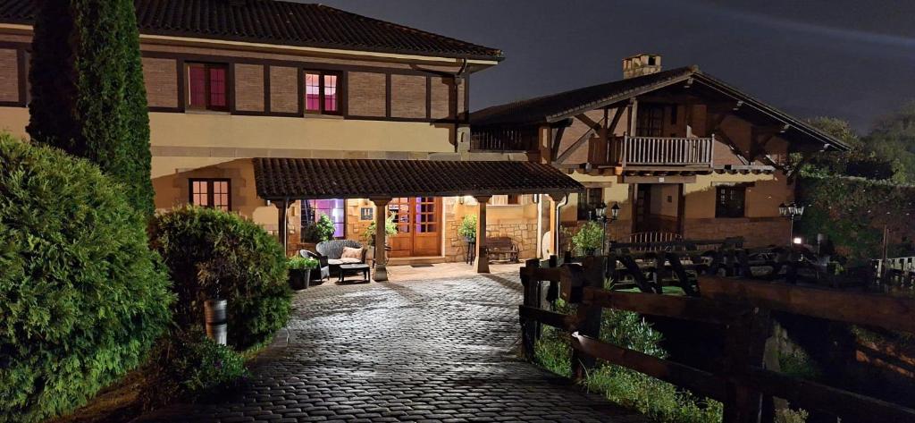 a stone walkway in front of a house at Hotel Artea Errota in Zamudio