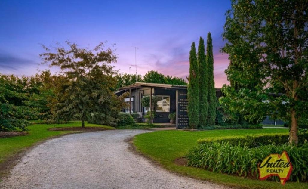 a home with a gravel driveway leading to a house at The Thirlmere Homestead in Thirlmere