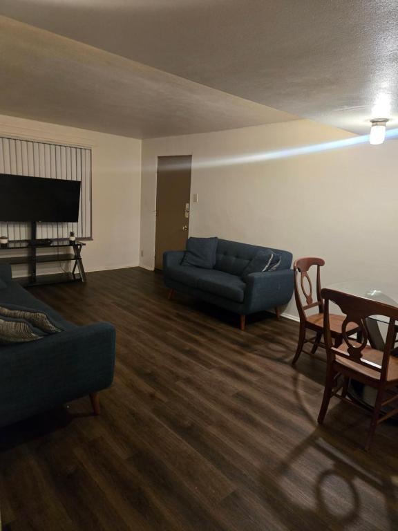a living room with a blue couch and a piano at Cute and Cozy in Hermann I Heliport
