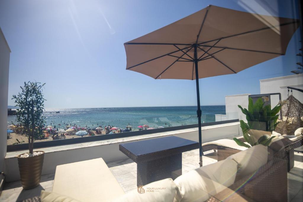 a balcony with a table and a view of the beach at Playablanca Luxury Beach Apartment First Floor in Tanger in Tangier