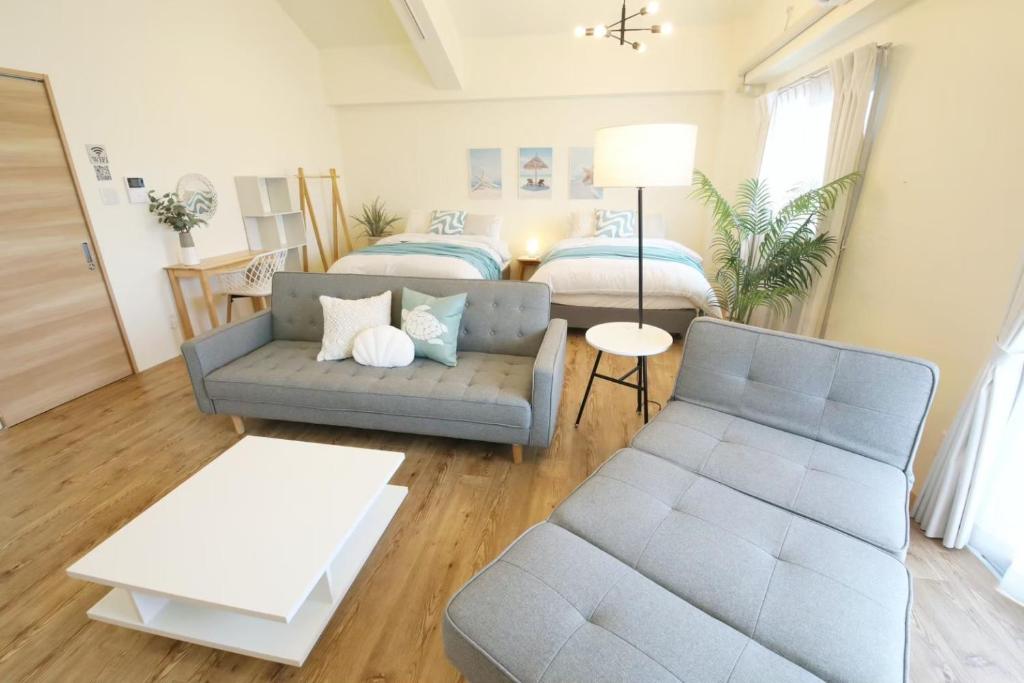 a living room with a couch and a bed at フサキリゾート Ishigaki 201 in Ishigaki Island