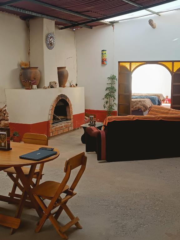 a living room with a table and a fireplace at Refugio tierra viva in Cusco
