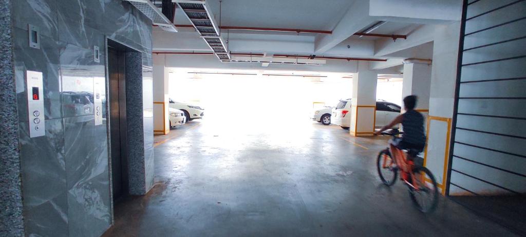 a person riding a bike in a parking garage at SPOTLESS HOSTEL, KILIMANi in Nairobi