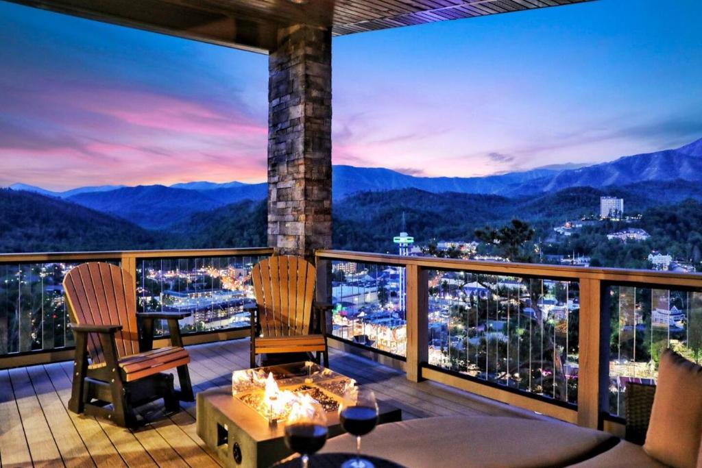 a balcony with a view of a city at night at Million Dollar Mountain Views in Gatlinburg