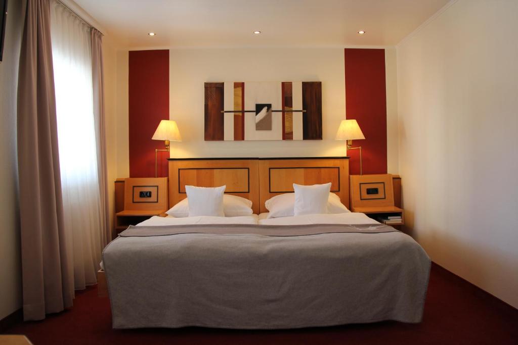 Ein Bett oder Betten in einem Zimmer der Unterkunft Hotel Riezler Hof