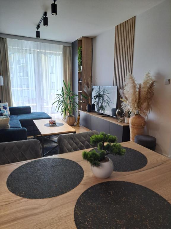 a living room with a table and a couch at Classic&Modern Suite in Kętrzyn