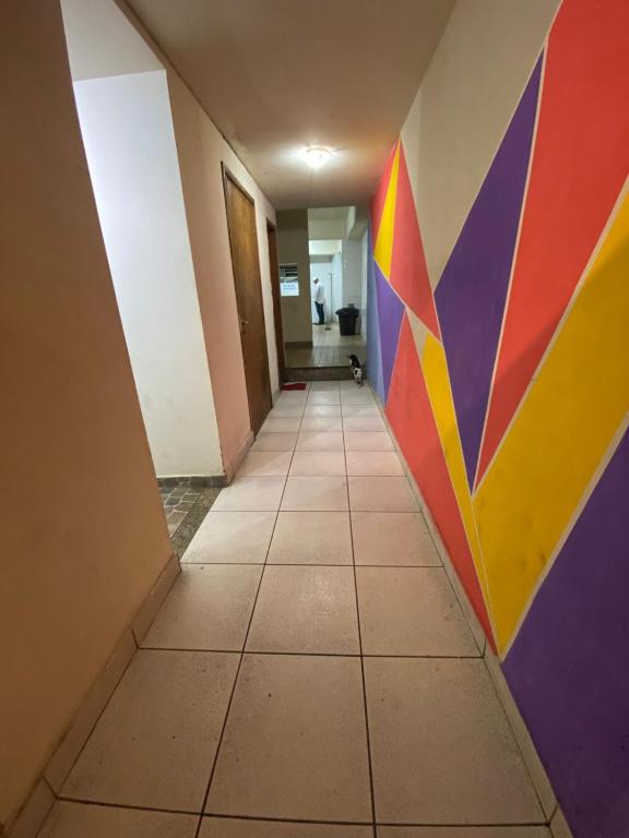 a hallway with a colorful wall in a room at Rede Quartos in São Paulo