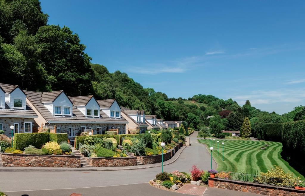 a row of houses on a golf course at Crylla Valley Cottages in Saltash
