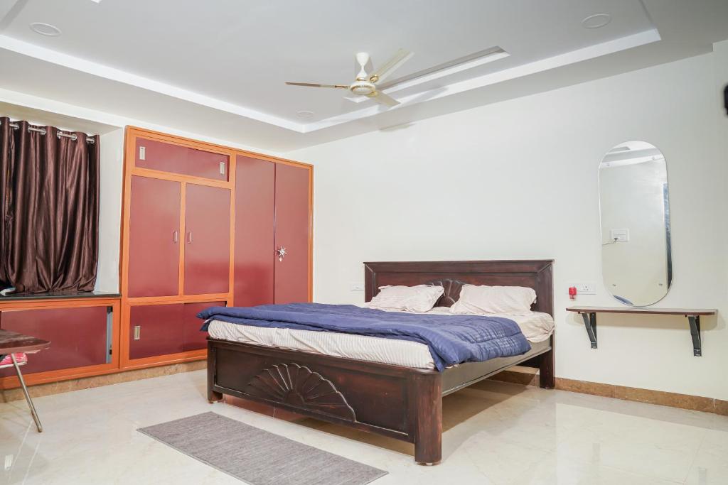 a bedroom with a bed and a ceiling fan at My3 rooms in Vijayawāda