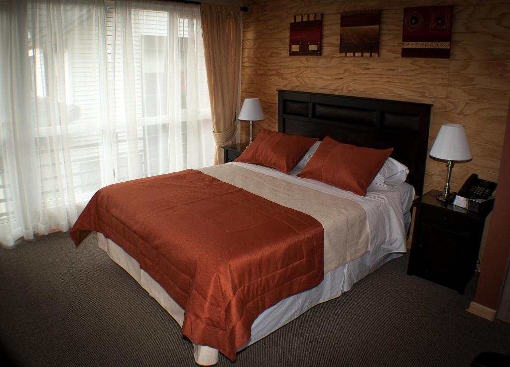 Voodi või voodid majutusasutuse Madero Aysen ApartHotel toas