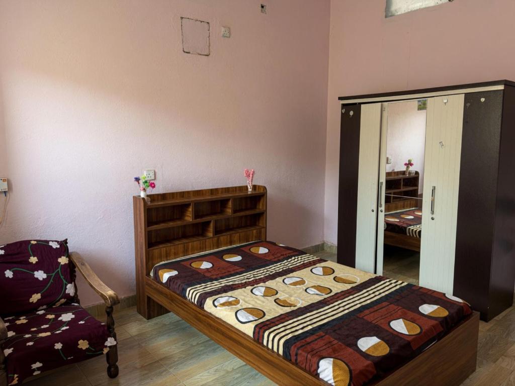 a bedroom with a bed and a mirror at Cozy Comfy 2 in Hithadhoo