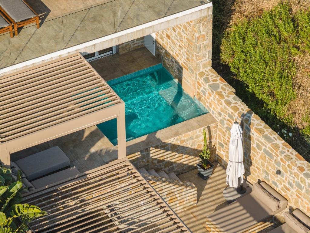 an overhead view of a swimming pool with a bench at Gialova Hills - Luxury Villa with Private Pool, Sauna, Garden & Seaview in Gialova