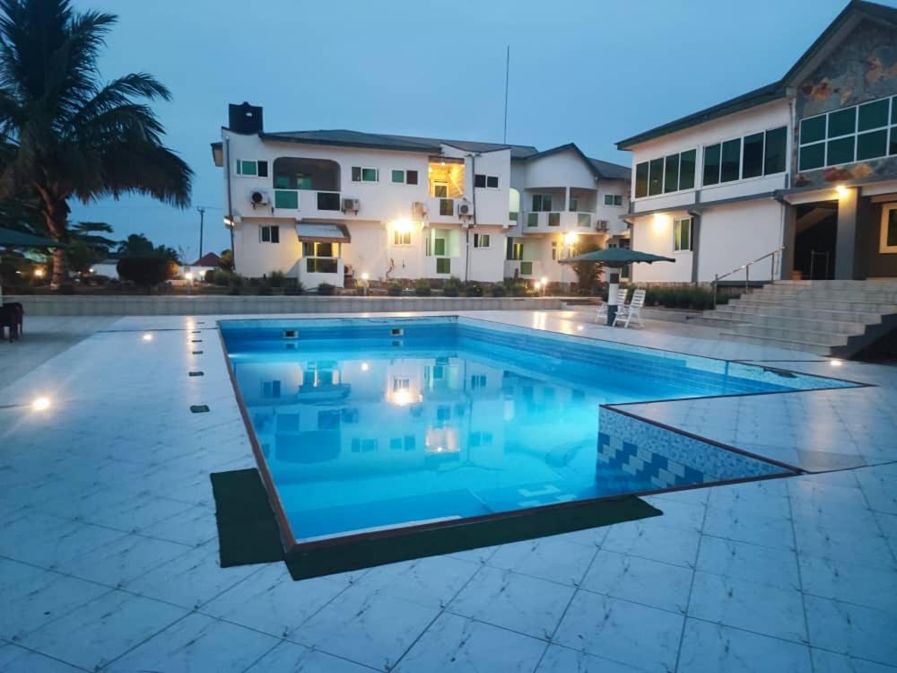 a large swimming pool in front of a building at Lois Beach Resort in Nyanyanu