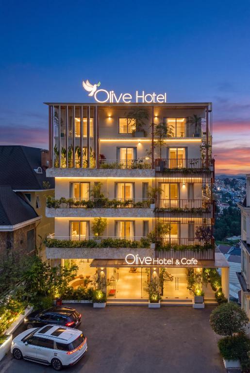 a hotel with a car parked in front of it at Olive Hotel Da Lat in Da Lat
