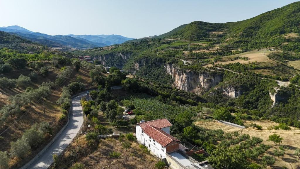 an aerial view of a mountain with a house and a road at Ferma Hodobashi in Çerenisht