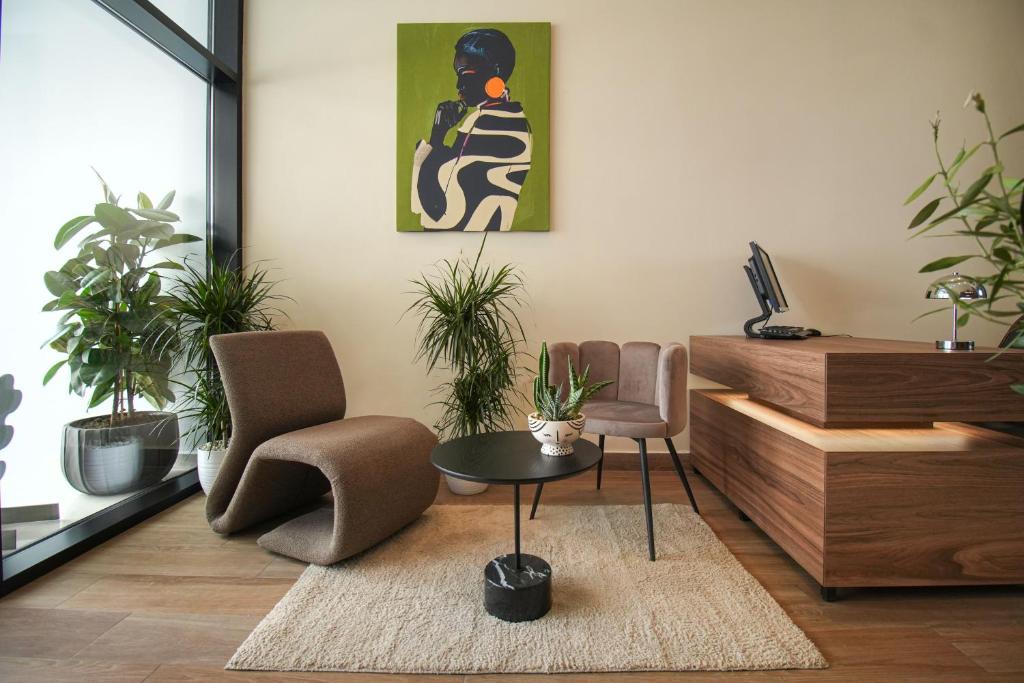a living room with two chairs and a table at Velorè Boutique Hotel in Tirana