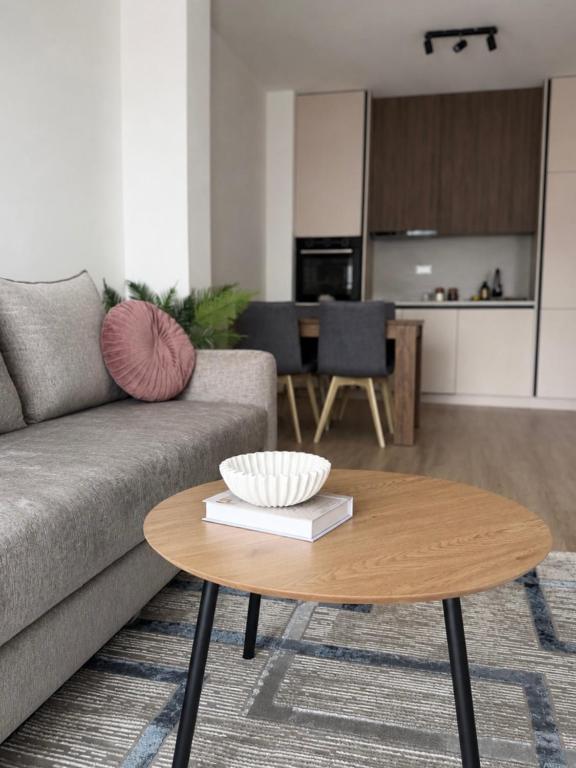 a living room with a couch and a coffee table at AURA apartment Vogošća, Sarajevo in Vogošća