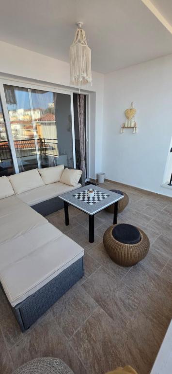 a living room with a couch and a table at Mista apartment in Peyia