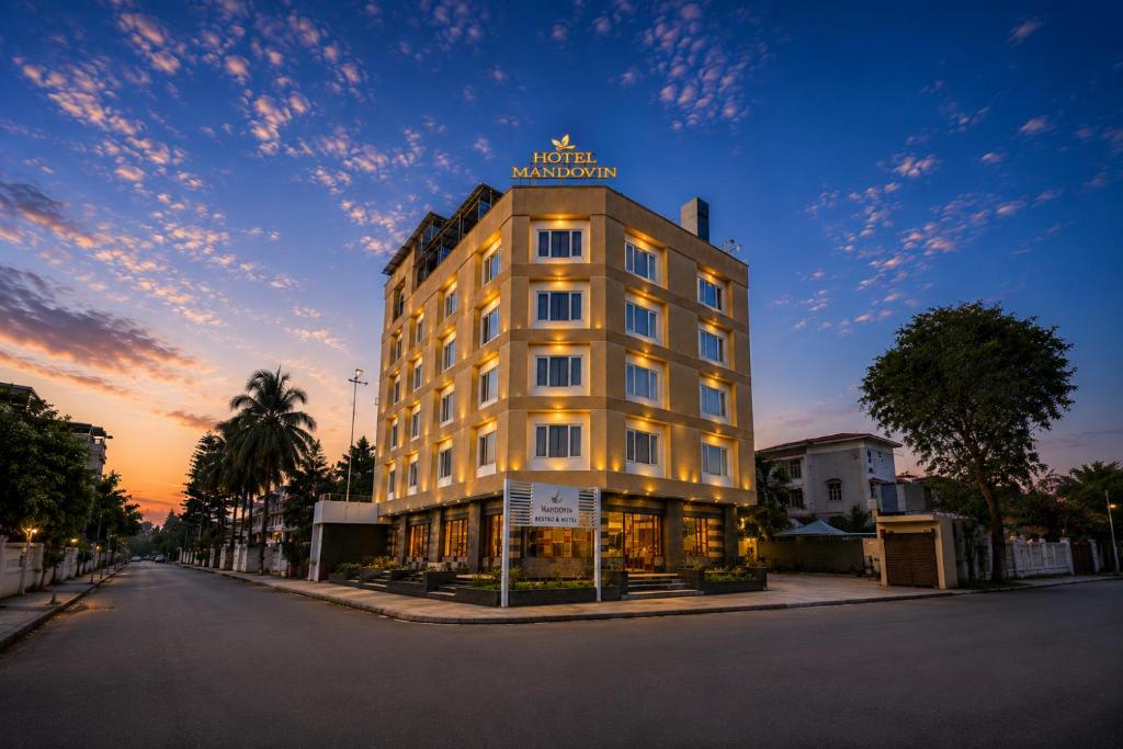 a building with a sign on the top of it at Hotel Mandovin - A Premium Hotel In Udaipur in Udaipur