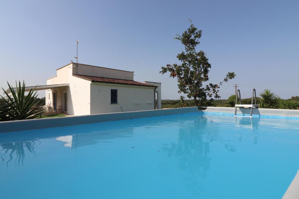 a large swimming pool in front of a house at Casale 50 Elegante Villa a Otranto in Otranto