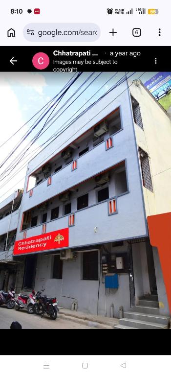 a building with motorcycles parked in front of it at Chhatrapati Residency in Tirupati