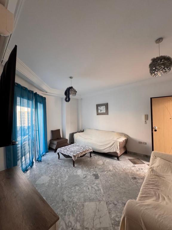a bedroom with a bed and a couch at Front de mer Chott Mariem in Chott Meriem