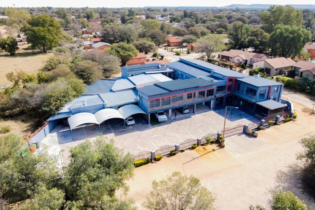 an overhead view of a large blue building with a stadium at The Royal Gem Hotel in Jwaneng