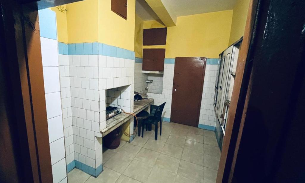 a kitchen with a counter and a table in a room at Foothill Lodge in Guwahati