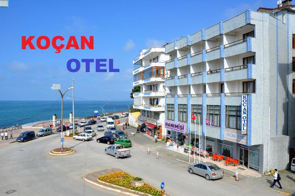 a view of a street with cars parked in front of a building at KOÇAN OTEL Hatice Karakoçan in Akçakoca