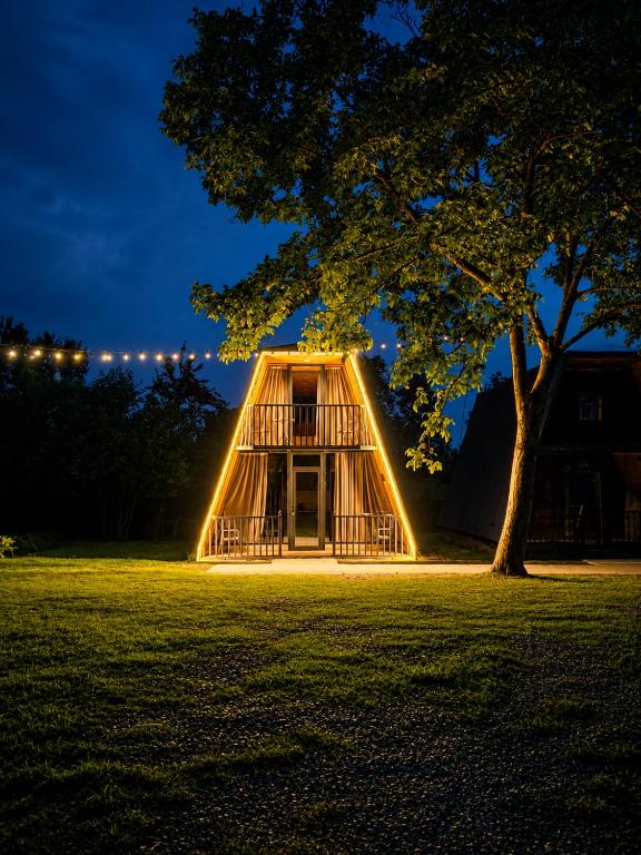 a tree house is lit up at night at Diamond Cottages in Lagodekhi