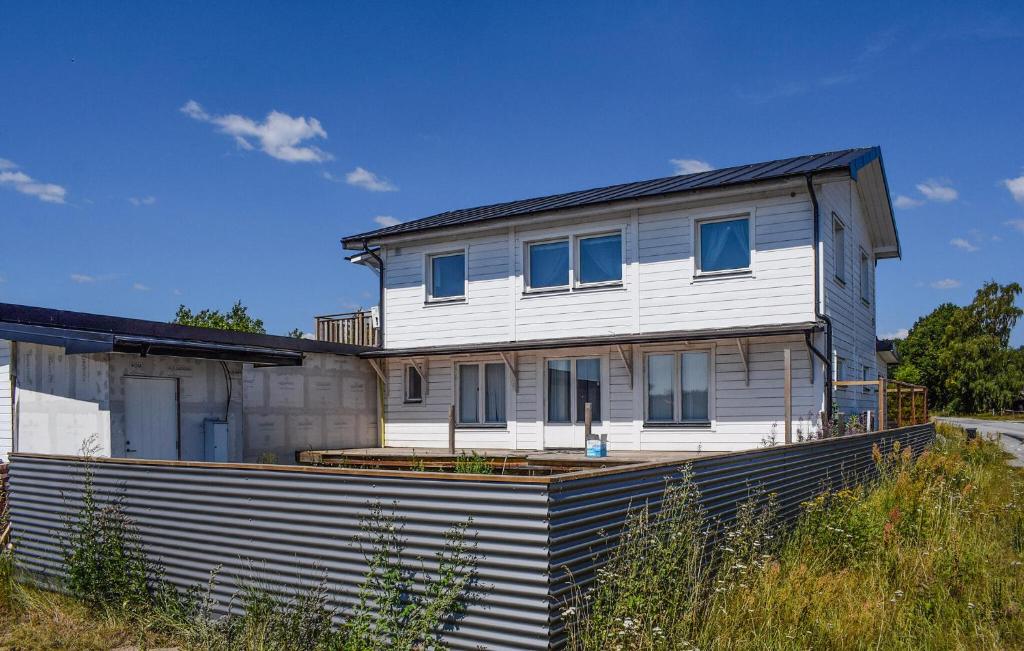 a white house sitting on top of a field at 3 Bedroom Nice Apartment In Sölvesborg in Sölvesborg